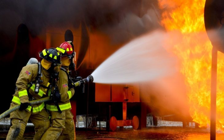 Two Fireman extinguishing fire