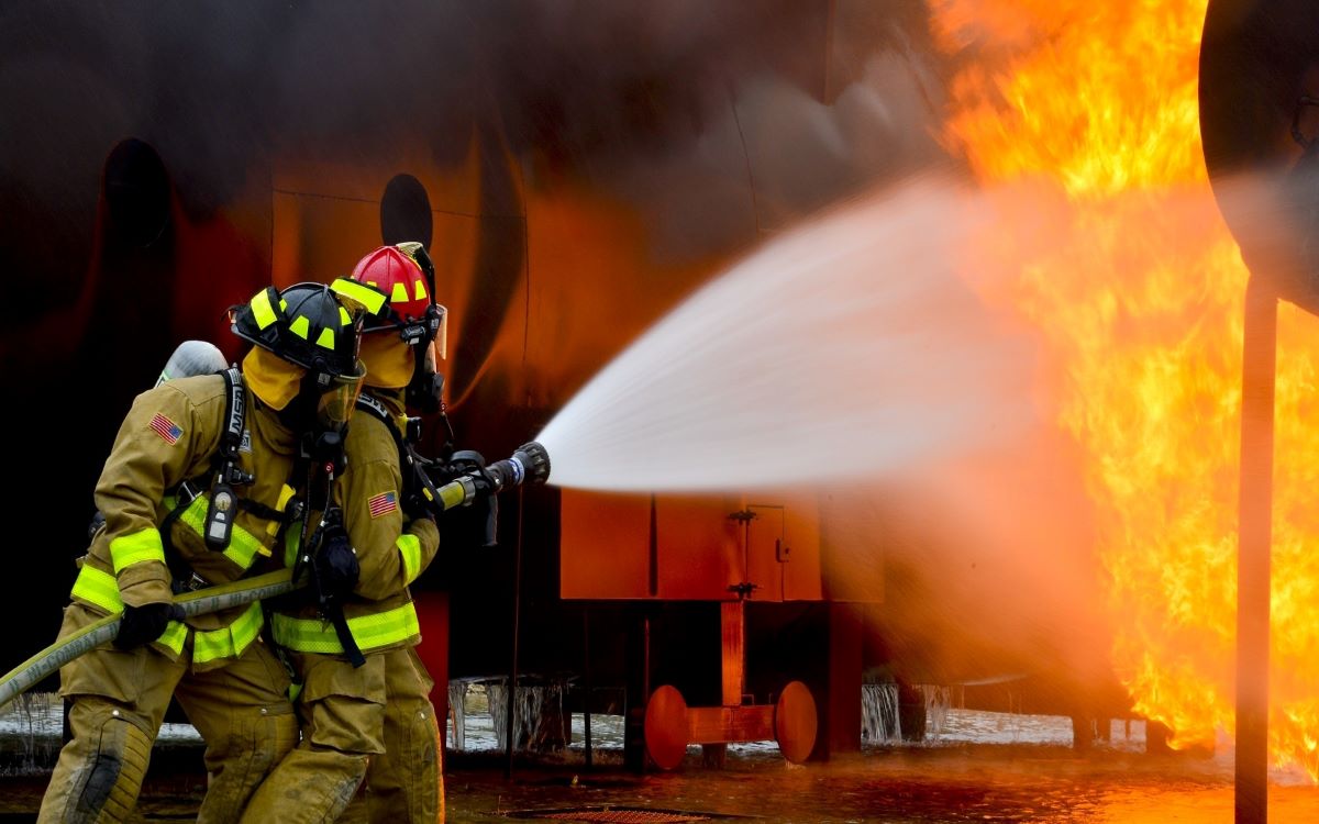 Two Fireman extinguishing fire