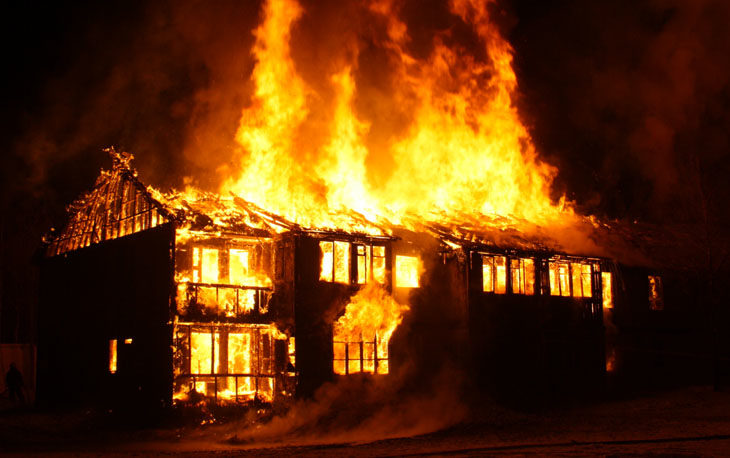 Large home on fire at night