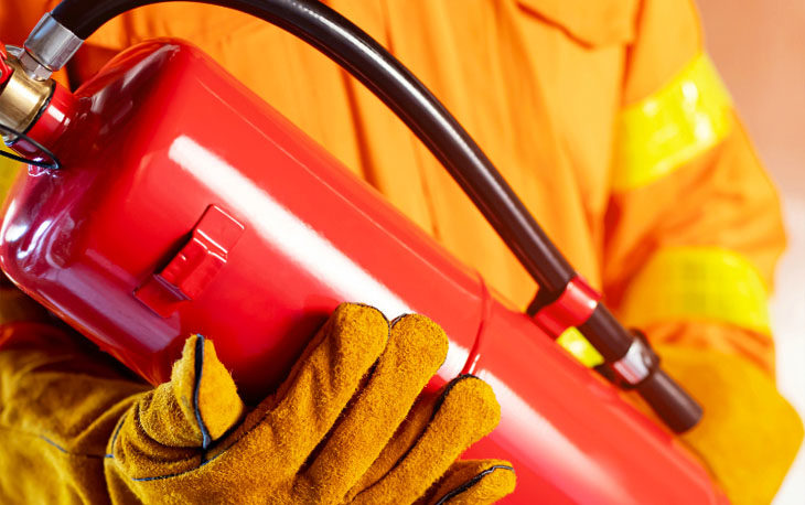 Fire Fighter holding a home fire extinguisher